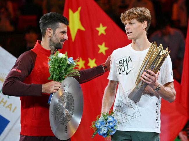 Novak Djokovic (L) doesn’t want to believe Jannik Sinner (R) is a doper. Picture: Hector Retamal/AFP