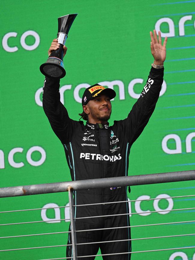 Mercedes' British driver Lewis Hamilton celebrates on the podium after placing second in the Formula One United States Grand Prix, at the Circuit of the Americas in Austin, Texas, on October 23, 2022. (Photo by Patrick T. FALLON / AFP)