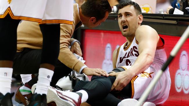 Andrew Bogut reacts after getting hurt 58 seconds into his Cleveland career