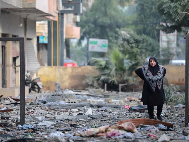 A woman looks at debris in Beirut’s southern suburbs as people returned to the area to check their homes after a ceasefire between Israel and Hezbollah took effect. Picture: AFP