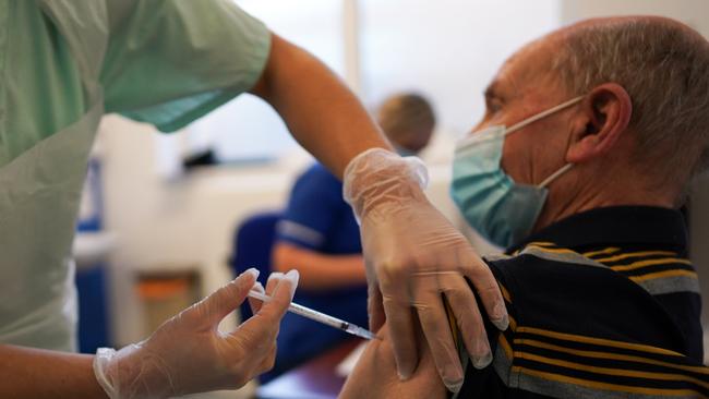 A man receiving one of the first COVID-19 vaccines earlier this month in the UK. Picture: Ian Forsyth/Getty