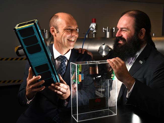 Dr Matthew Tetlow from Inovor Technologies holding a 3U CubeSat, with Dr Patrick Neumann with a demo of the pulsed cathodic arc thruster. Picture: Tricia Watkinson