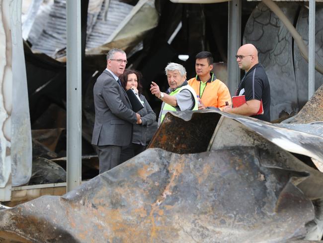 Joe Giangregorio speaks to fire-cause investigators at the scene. Picture: Tait Schmaal