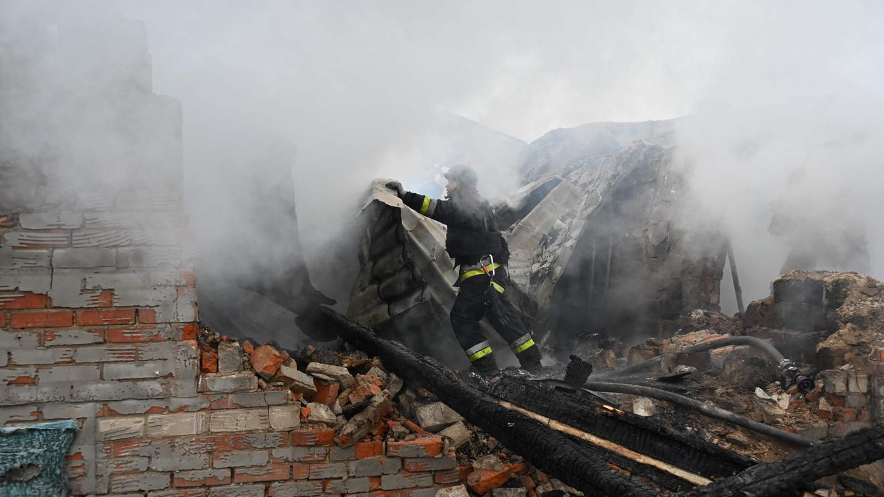 A rescuer of the State Emergency Service works to put out a fire in a private house after a drone strike in Kharkiv. Picture: Sergey Bobok/AFP