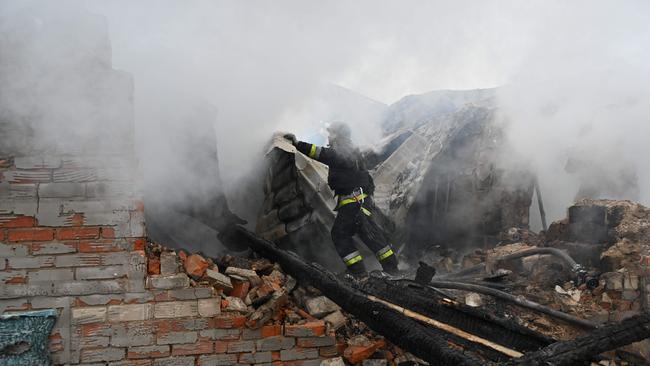 A rescuer of the State Emergency Service works to put out a fire in a private house after a drone strike in Kharkiv. Picture: Sergey Bobok/AFP