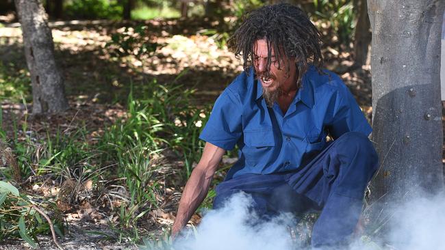 Joshua Walker performs a smoking ceremony on North Stradbroke Island. Photo: AAP/John Gass.