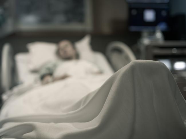 Sick woman lying in the hospital bed.