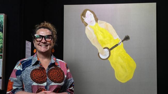 Brisbane Portrait Prize judge Lisa Slade with work by artist Darren McDonald called Like a Bridge at the Brisbane Portrait Prize exhibition. Picture: Zak Simmonds