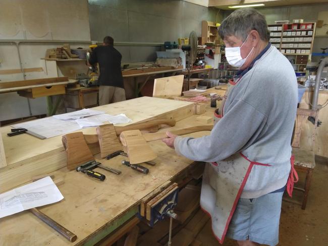 Grafton Men's Shed member Derek Latimer hard at work creating some of more than 50 axes the shed is producing for local sawmills.