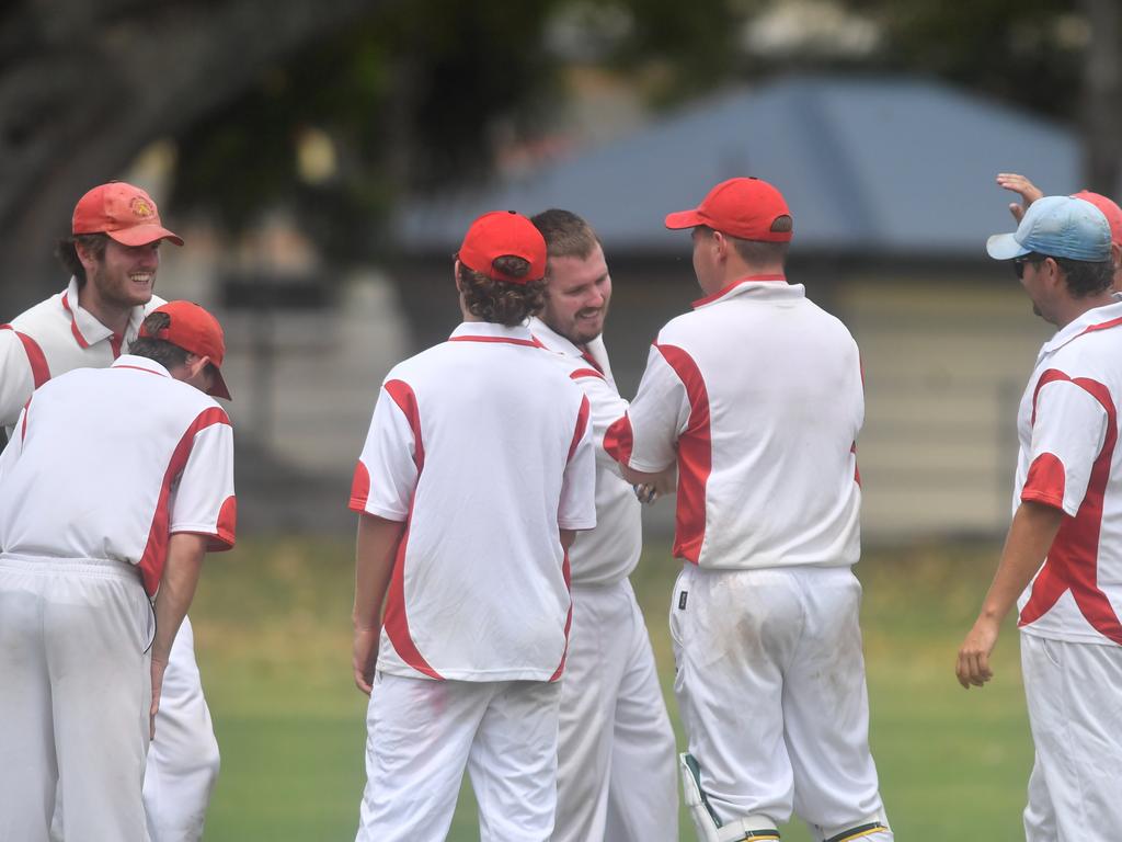 Chris Cleaver is congratulated by his Souths Services teammates for a wicket against Brothers at McKittrick Park