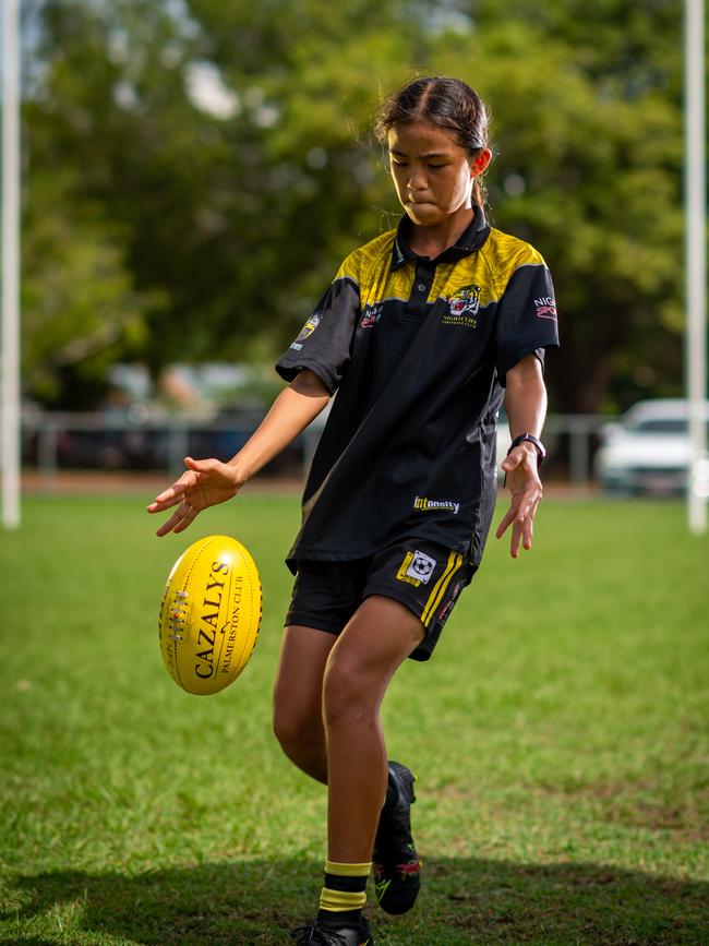 Nightcliff Tigers junior Peggy Rock is part of a generation of girls growing up playing footy with an abundance of stars to look up to and a clear path to the top level. Photograph: Che Chorley