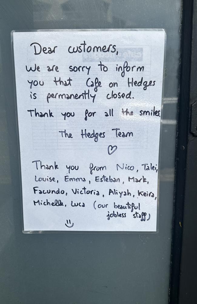 A handwritten sign on the front door of Cafe On Hedges, on the corner of Montana Road and Hedges Ave, reads: “Dear customers, we are sorry to inform you that Cafe on Hedges is permanently closed. Thank you for all the smiles, the Hedges Team … (our beautiful jobless staff).”,