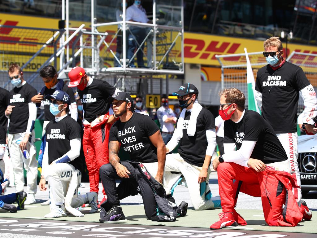 Kimi Raikkonen (right) said his was an individual decision to stand. (Photo by Mark Thompson/Getty Images)