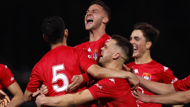 FC Melbourne celebrate winning on penalties.