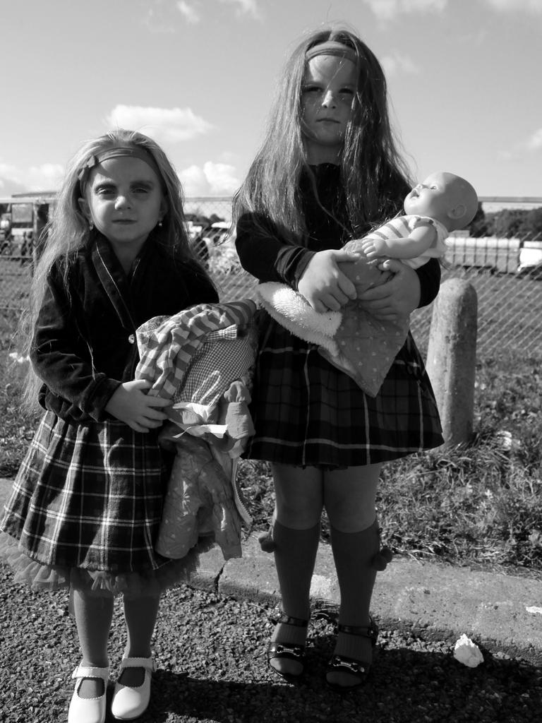 Two girls hold their dolls. Picture: Jamie Johnson