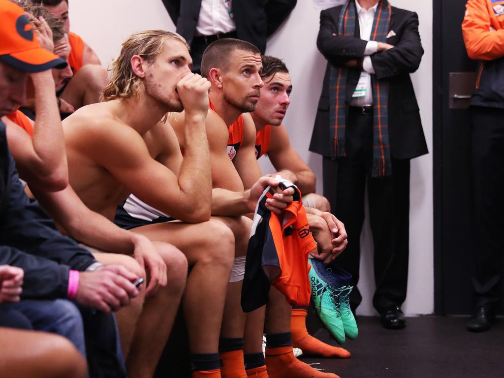 Nick Haynes, Brett Deledio listen in to coach Leon Cameron as he gives them his post match talk. Picture: Phil Hillyard