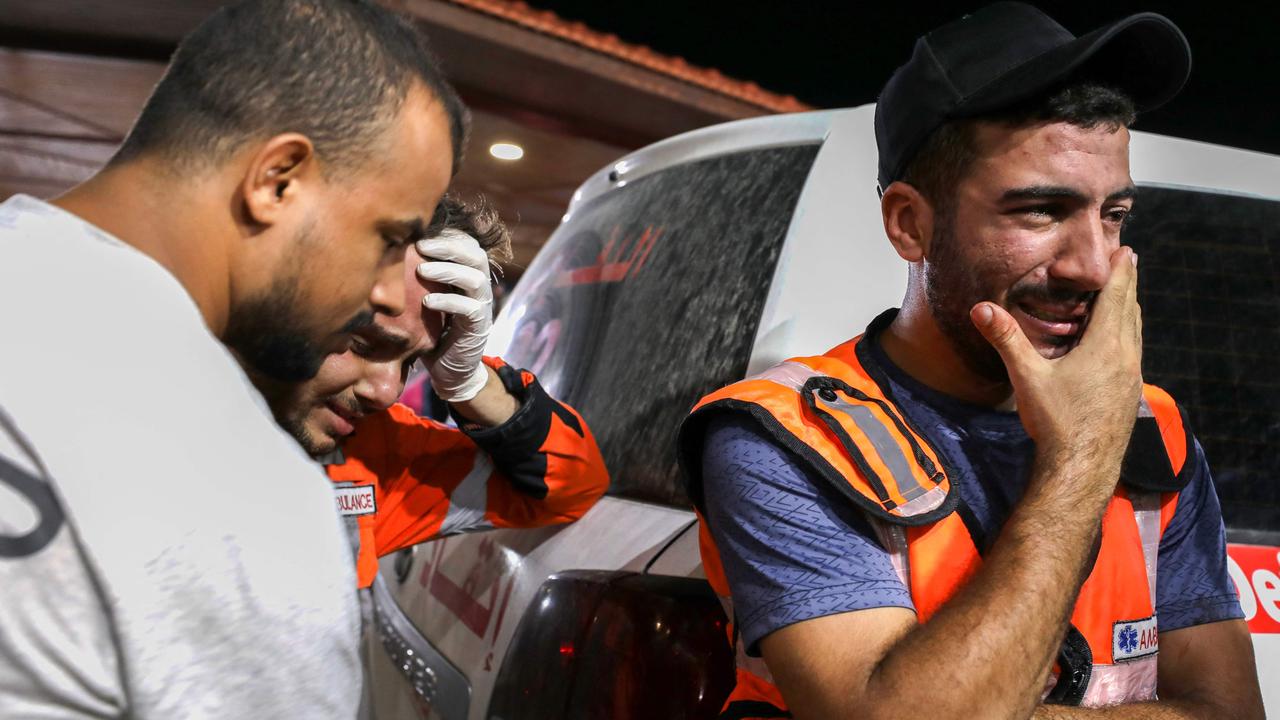 Palestinian paramedics cry in the wake of a devastating blast at a hospital in Gaza. Picture: Getty