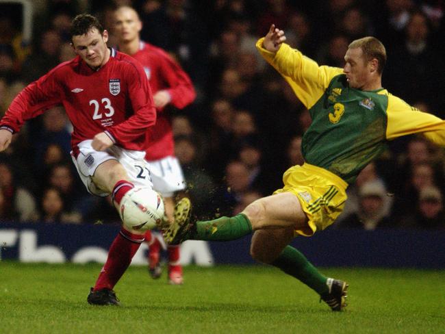 LONDON - FEBRUARY 12: Wayne Rooney (No.23) of England shoots towards goal as Craig Moore of Australia closes him down during the International Friendly match between England and Australia held on February 12, 2003 at Upton Park in London. Australia won the match 3-1. (Photo By Jamie McDonald/Getty Images)