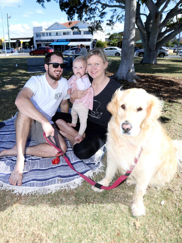 Brock, Jemma, and Lily Buckley with dog Mintie the golden retriever at Sandgate Beach. Picture: Steve Pohlner