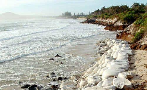 Sand bags being used to hold back the tide of coastal erosion at The Belongil in Byron Bay.