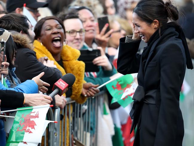 Meghan Markle talks to a member of the public as she arrives to a walkabout at Cardiff Castle on January 18, 2018 in Cardiff, Wales. Picture: Getty