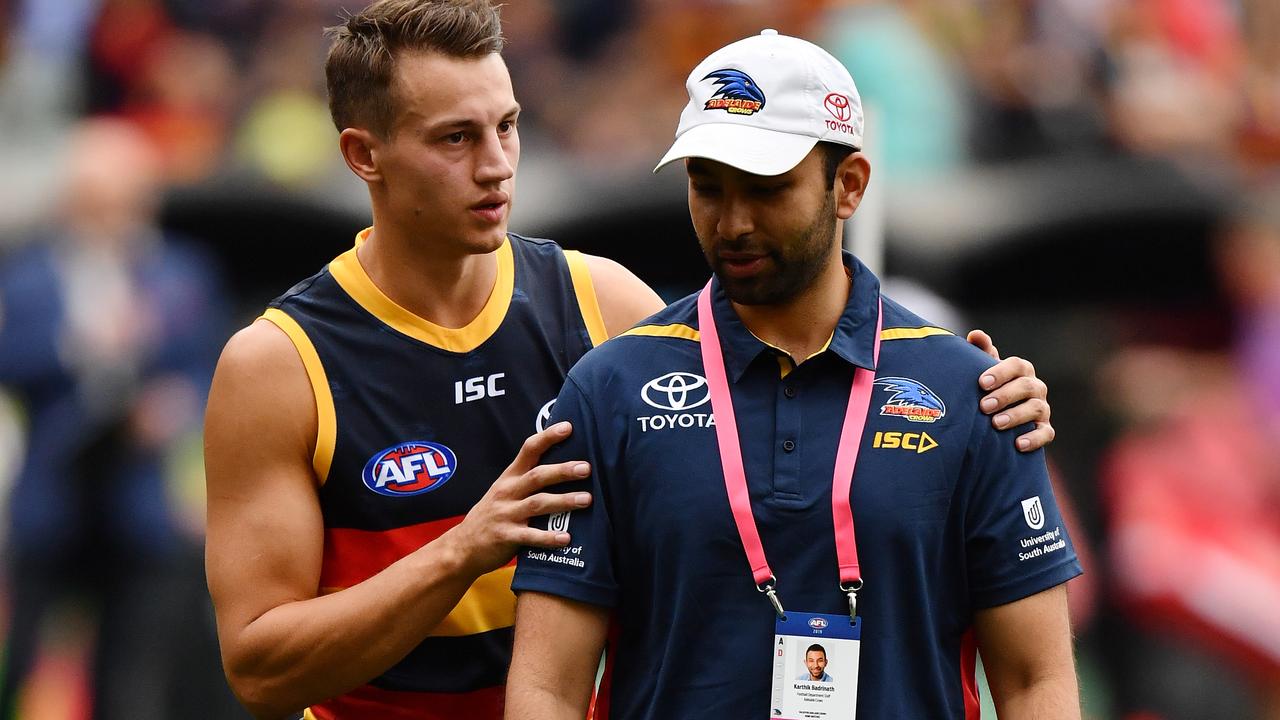 Tom Doedee of the Crows walks from the ground at half time after rupturing his ACL. Picture: Daniel Kalisz/Getty Images