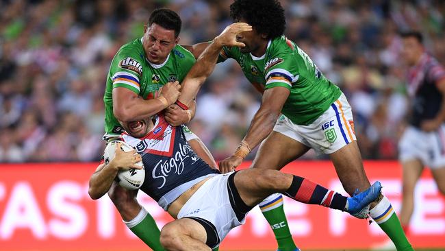 James Tedesco of the Roosters is tackled by Joseph Tapine (left) and Iosia Soliola. Picture: AAP Image/Dan Himbrechts