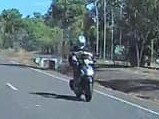 A motorcyclist at McMinns Lagoon has been captured riding with his feet to free up his hands in order to fire off a text message. Picture: Facebook