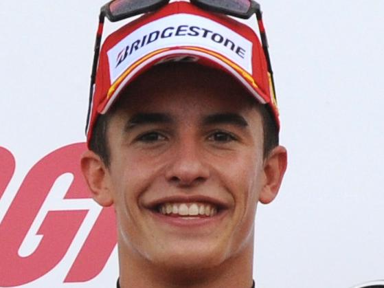 Spain's Marc Marquez of Repsol Honda, center, celebrates on the podium after winning the MotoGP British Grand Prix, with second place Spain's Jorge Lorenzo of Movistar Yamaha, right, and third place Italy's Valentino Rossi of Movistar Yamaha, left, at Silverstone, England, Sunday, Aug. 31, 2014. (AP Photo/Rui Vieira)