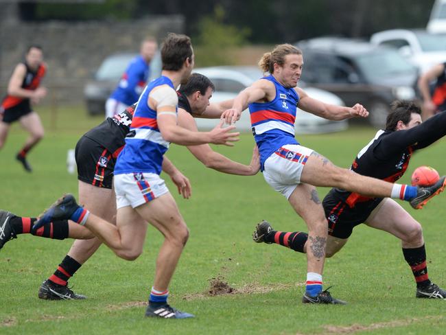 MPNFL Division 1: Frankston Bombers v Mornington at Baxter Park. Mornington #10 Ryan Odell  boots his team forward as Frankston #11 Waide Symes tries to smother the ball.  Picture: AAP/Chris Eastman