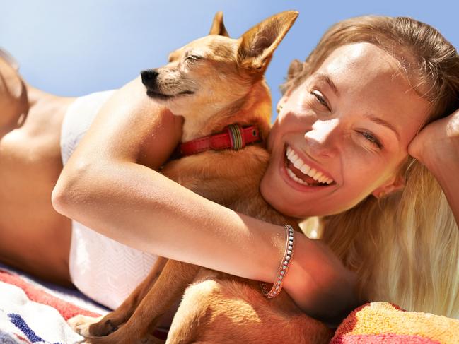 Portrait of a beautiful young woman and her dog at the beach  Picture: istock