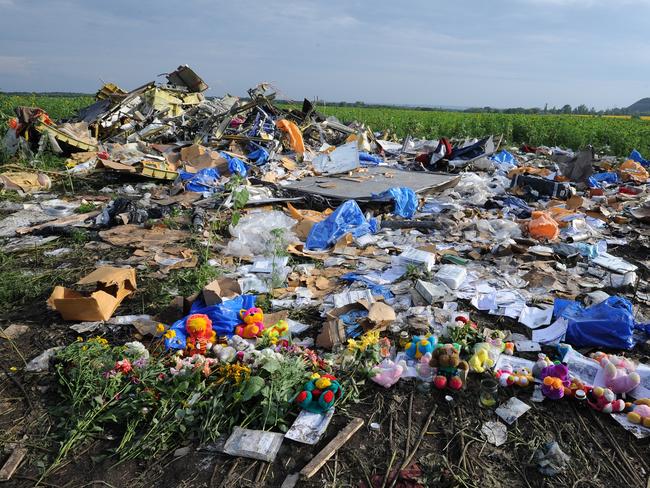 Flowers and plush toys are left at the site of the crash of a Malaysia Airlines plane carrying 298 people from Amsterdam to Kuala Lumpur in Grabove, in rebel-held eastern Ukraine, on July 19, 2014. Picture: AFP