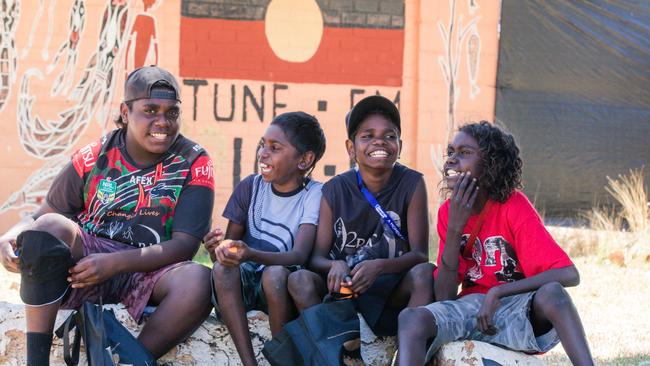 Tyquan Wilfred , Leo Hall , Stretton Cooper and Nick Bonson relax in the shade a weekend of Music, Sport and Culture at the Barunga Festival. Picture Glenn Campbell