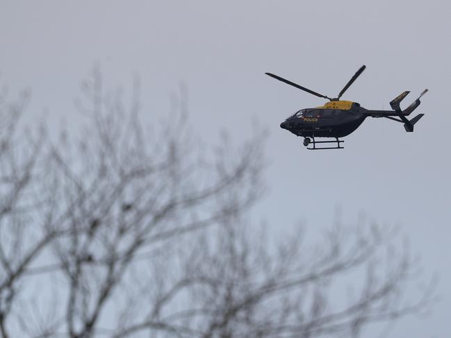 A police helicopter flies over Gatwick Airport as they search for the Drone operator causing closure of the airport. Picture: Getty