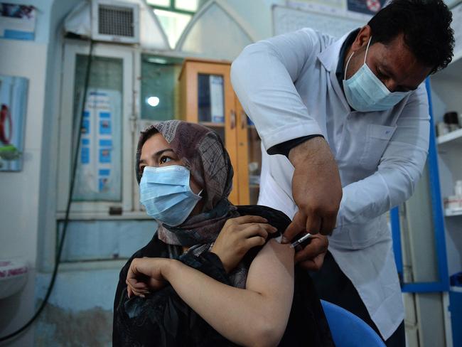 A health worker innoculates a female prisoner with a dose of the Covishield, AstraZeneca-Oxford's coronavirus vaccine, at a prison in Herat. Picture: AFP