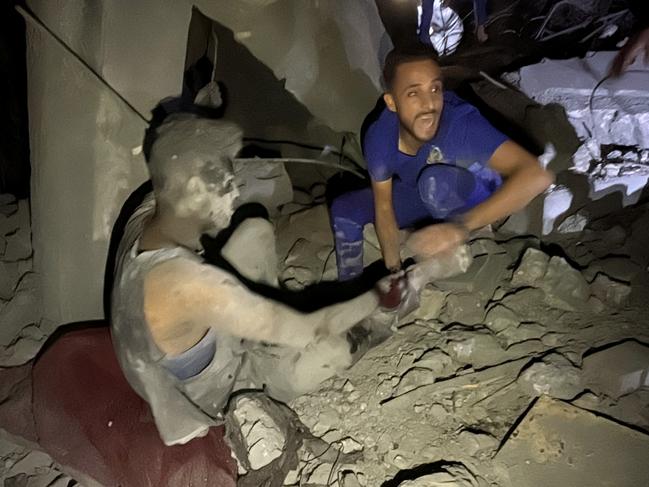 A man shouts as he pulls a survivor from the rubble of a building following an Israeli strike near the Kamal Adwan hospital in Beit Lahia, in the northern Gaza Strip. Picture: AFP