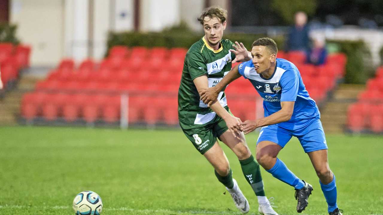 CLOSE CONTROL: South West Queensland Thunder striker Travis Cooper (right) attempts to work his way past Western Pride's Nielen Brown. Picture: Nev Madsen