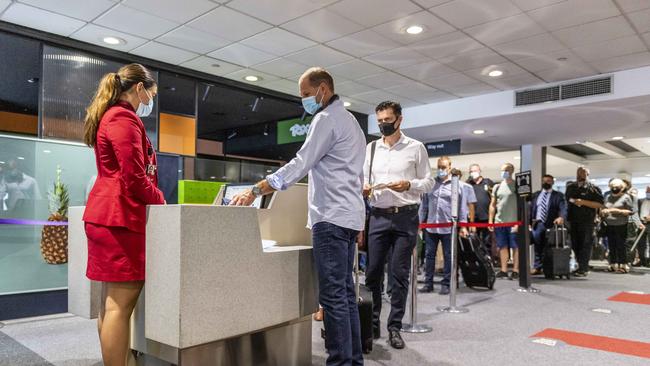 People prepare to travel to Sydney from Melbourne’s Tullamarine. Picture: Jake Nowakowski