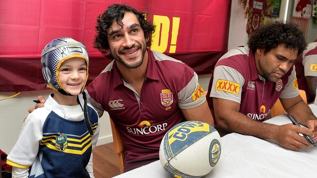 PROSERPINE, AUSTRALIA - JUNE 30: Johnathan Thurston poses for a photo with a young fan during the Queensland Maroons State of Origin fan day on June 30, 2015 in Proserpine, Australia. (Photo by Bradley Kanaris/Getty Images)