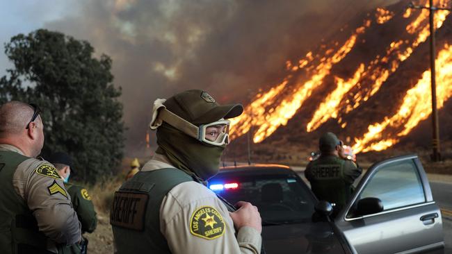 Los Angeles County Sheriff’s deputies keep watch as the Hughes Fire burns north of Los Angeles. Picture: Getty Images via AFP.