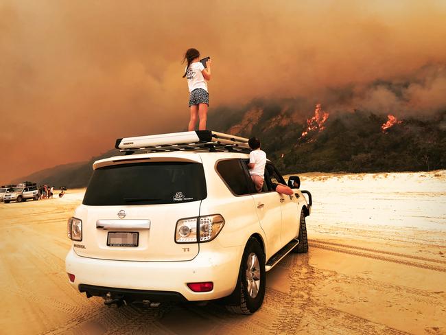 The fire on Fraser Island on Saturday, November 14, 2020.Hollie Neagle and her family are vacationing on the island. Pictured is Hollie's daughter Ruby and son Harley.Picture: Hollie Neagle