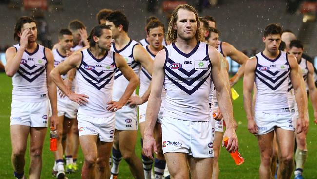 MELBOURNE, AUSTRALIA - JUNE 24: The Dockers leave the field after they lost the round 14 AFL match between the Collingwood Magpies and the Fremantle Dockers at Melbourne Cricket Ground on June 24, 2016 in Melbourne, Australia. (Photo by Scott Barbour/Getty Images)