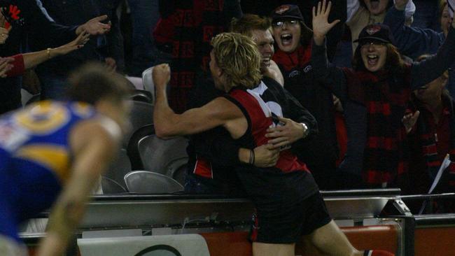 Footballer James Hird hugging with fan supporter after kicking winning goal.AFL football - Essendon vs West Coast Eagles match at Telstra Dome 10 Apr 2004.