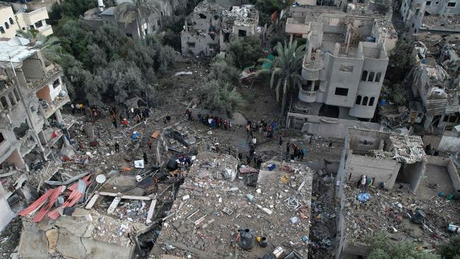 Palestinians inspecting the damage at the Al-Maghazi refugee camp after an overnight Israeli strike on December 25. Picture: Mahmud Hams/AFP