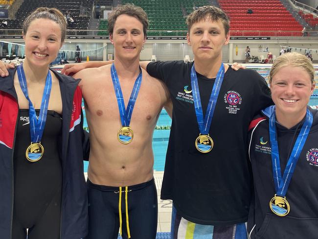 (Left to right) Georgina Seton, 21, Cameron McEvoy, 28, Joshua Kerr, 16 and Lillie McPherson 13, with their gold medals after winning the Mixed 50m freestyle relay for the Manly Swimming Club at the Australian Shortcourse Swimming Championships. Picture: Manly Swimming Club