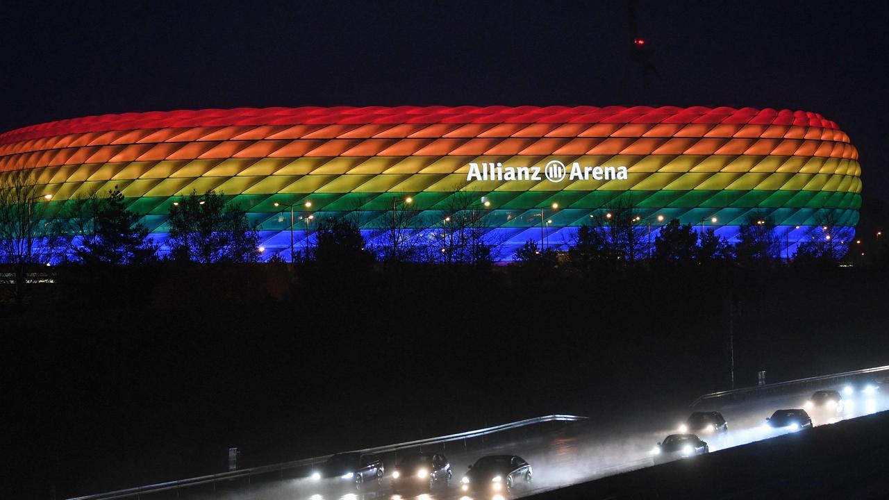 (FILES) In this file photo taken on January 30, 2021 traffic passes the Allianz Arena illuminated in the rainbow colours after the German first division Bundesliga football match FC Bayern Munich v TSG 1899 Hoffenheim in Munich, southern Germany. - UEFA on June 22, 2021 rejected plans by the city of Munich to light the Allianz Arena in rainbow colours for the Germany-Hungary Euro 2020 match to protest at a law passed by the Hungarian government. "UEFA is a politically and religiously neutral organisation," said European football's governing body in a statement. (Photo by Andreas GEBERT / POOL / AFP)