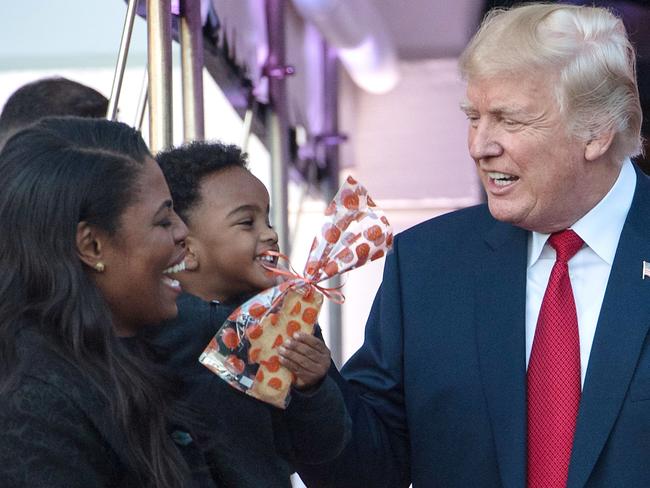 (FILES) In this file photo taken on October 30, 2017 US President Donald Trump speaks with aide Omarosa Manigault (L) as he hands out candy to children during a Halloween event at the White House in Washington, DC. - Former White House staffer and TV celebrity Omarosa Manigault Newman has released a recording of a private conversation with President Donald Trump after she was fired. NBC's 