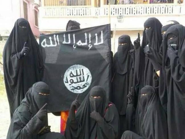 Islamic State brides, dressed from head to toe in deep black, pose with the flag of the Caliphate and issue the finger-pointing-to-heaven salute.