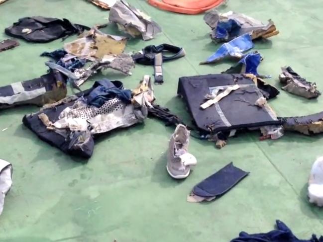 FILE - This file still image taken from video posted Saturday, May 21, 2016, on the official Facebook page of the Egyptian Armed Forces spokesman shows some personal belongings and other wreckage from EgyptAir flight 804 in Egypt. Human remains retrieved from the crash site of EgyptAir Flight 804 suggest there was an explosion on board that may have brought down the aircraft in the east Mediterranean, a senior Egyptian forensics official said on Tuesday, May 24, 2016. (Egyptian Armed Forces via AP, File)