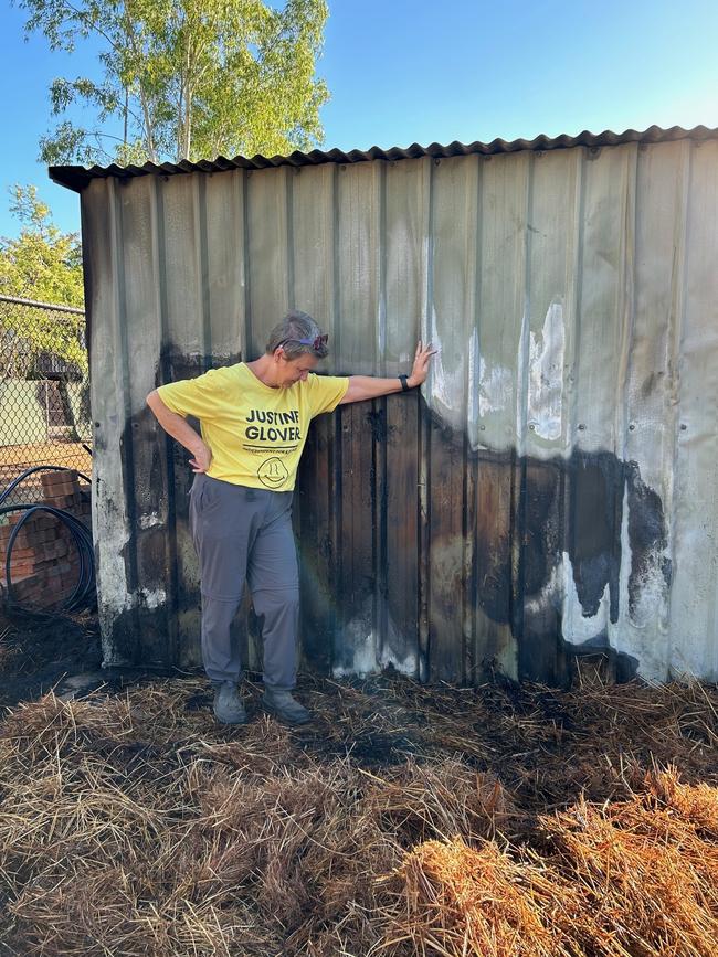 Karama Community Garden committee member Justine Glover looks at the wreckage of the group's shed after a wayward firework burned it down on Territory Day, 2024.